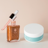 Brown bottle with dropper and white jar on a beige background