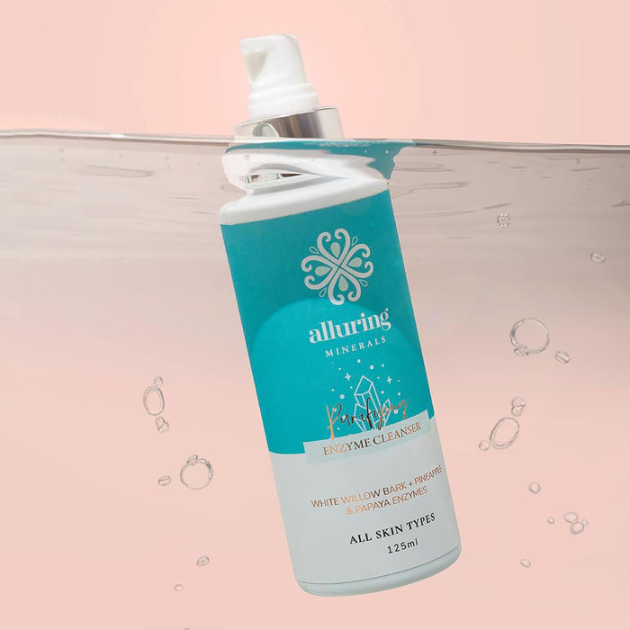 Alluring Minerals Purifying Enzyme Cleanser bottle half submerged in water