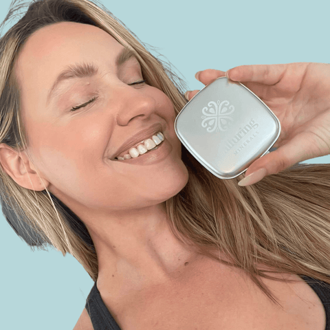 Customer holding an Alluring Minerals Mineral Baked Blush compact to her cheek